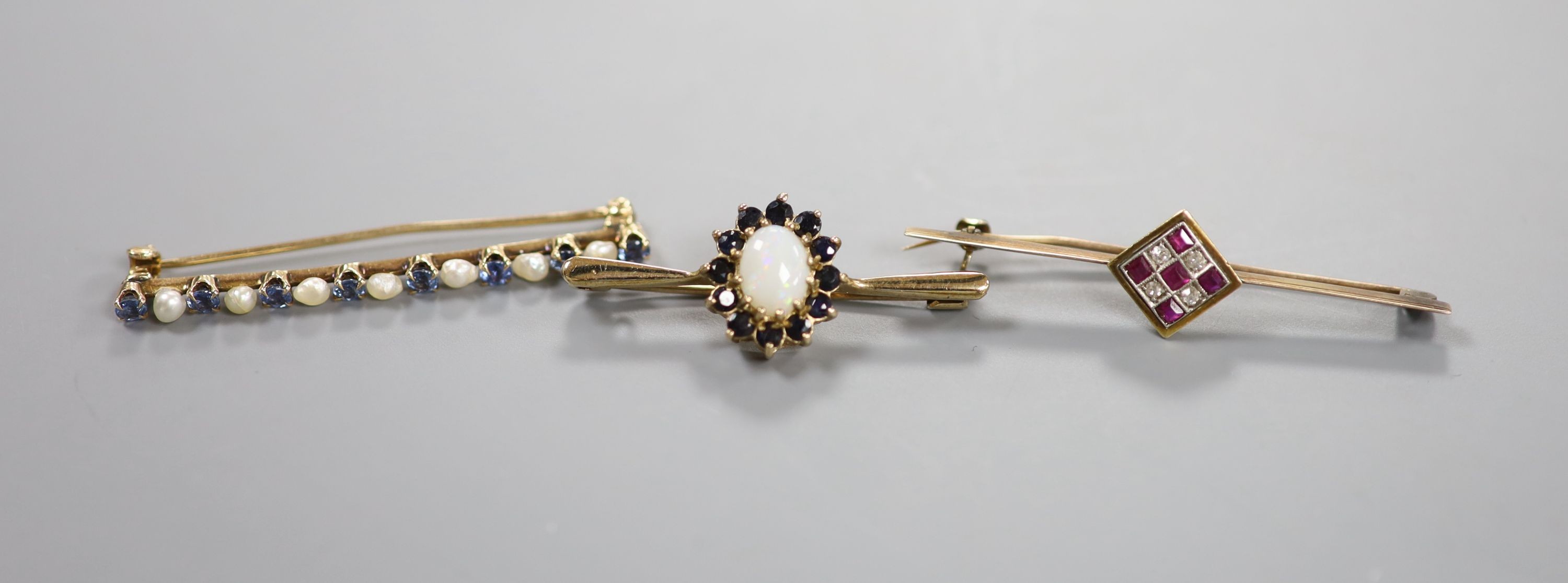 Two yellow metal and gem set bar brooches including ruby and diamond cluster, 46mm, gross 4.3 grams, a modern 9ct gold, white opal and sapphire cluster bar brooch, gross 3.1 grams and a cultured pearl set bar brooch.